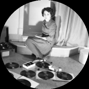 A young women posing with phonograph records and a record player.